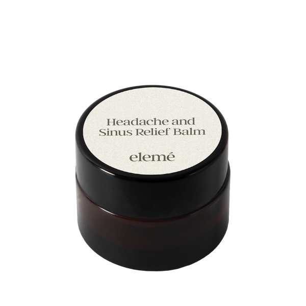 Black jar of elemé headache and sinus relief balm on a white background